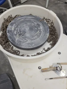 Trimming clay on the pottery wheel
